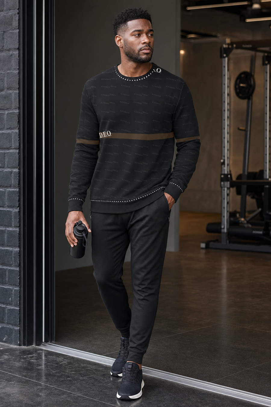 Man in black athletic wear standing in a gym setting