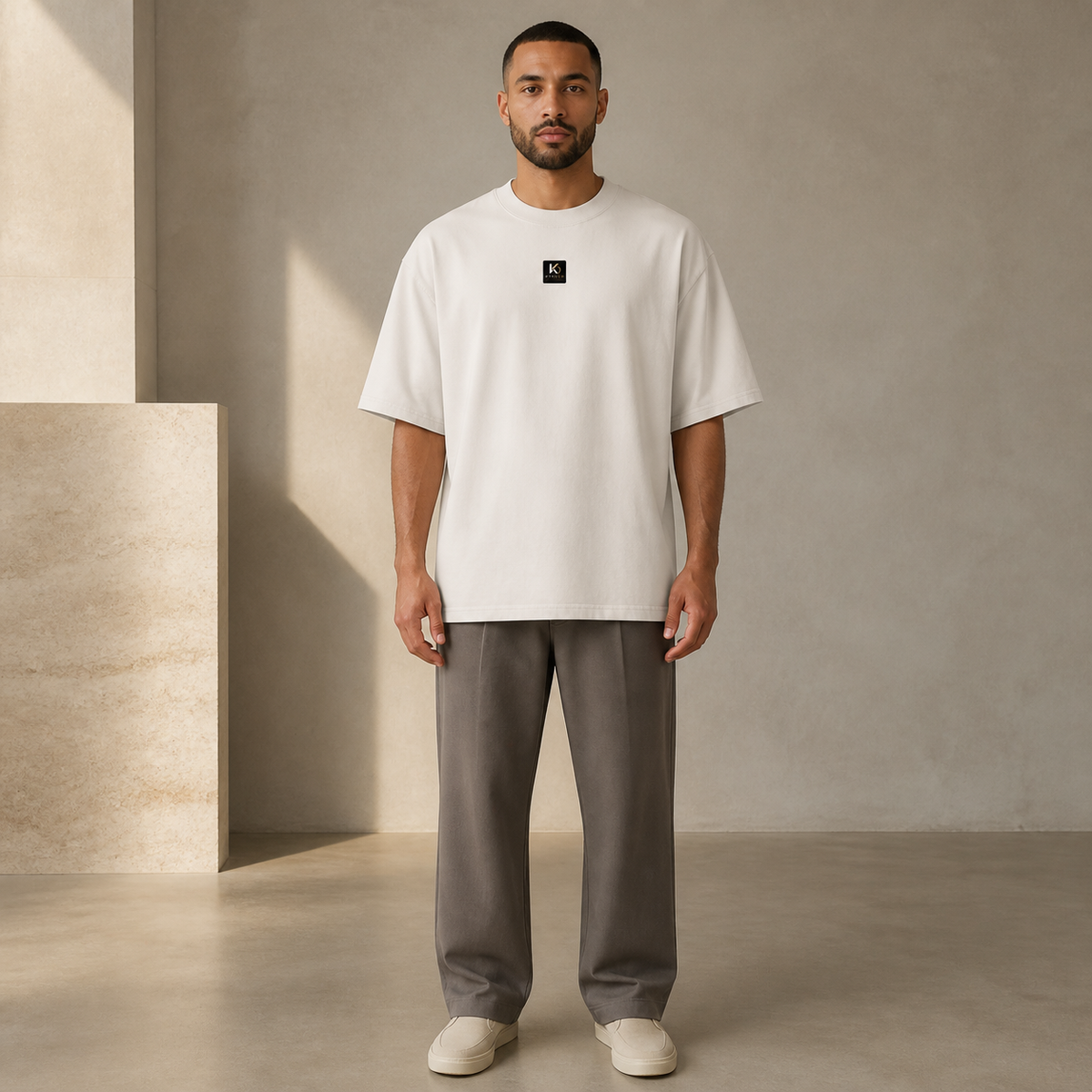KYNDEO Fadeweight Oversized Tee in faded bone, complete front lifestyle view on an Afro-Latino male model