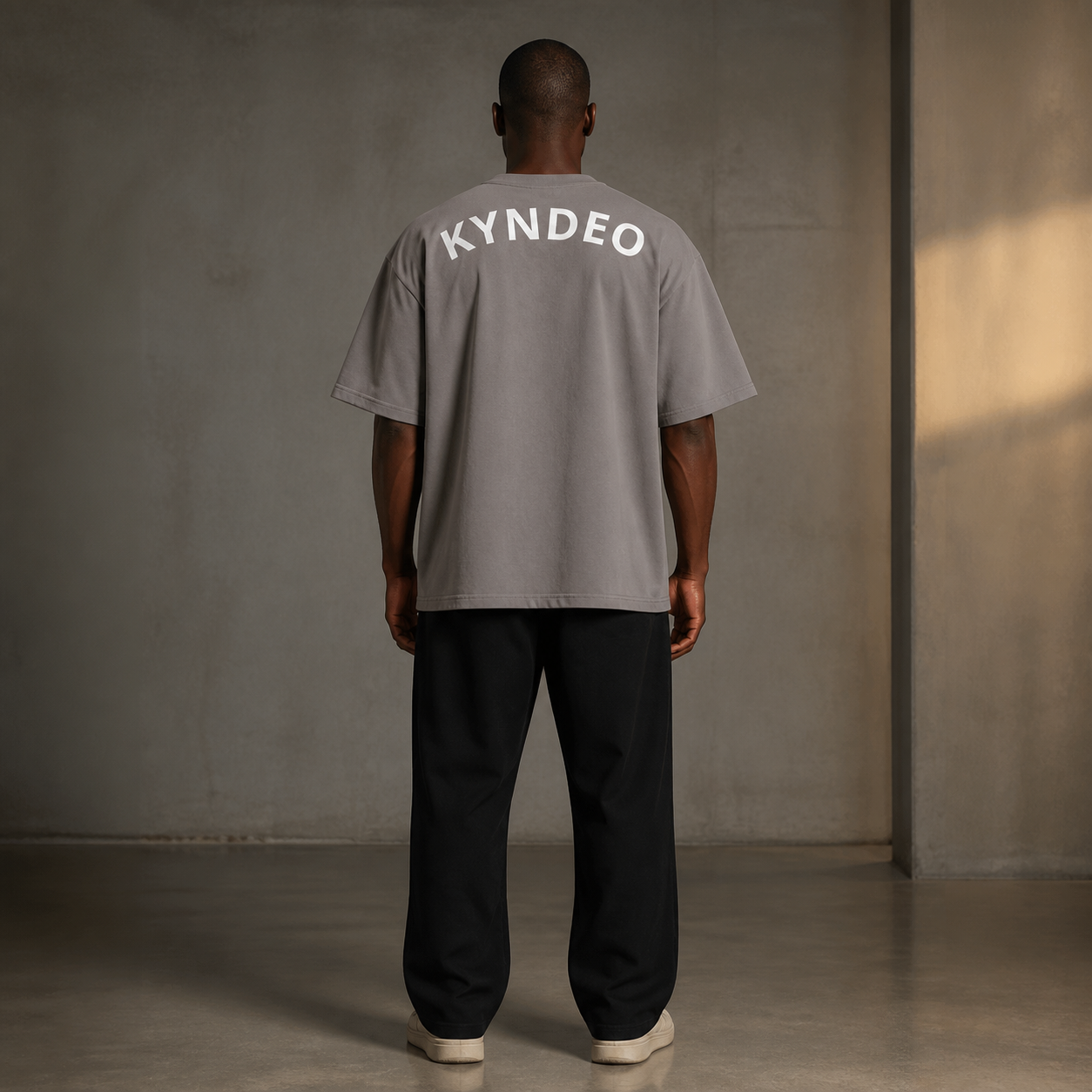 KYNDEO Fadeweight Oversized Tee in faded grey, complete back lifestyle view on a Black male model showing the rear KYNDEO wordmark