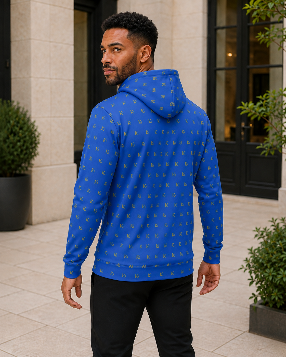 KYNDEO Forge Hoodie - Royal Monogram in royal blue with small gold KD repeat, rear three-quarter lifestyle view
