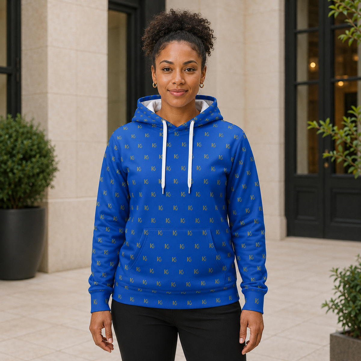 KYNDEO Forge Hoodie - Royal Monogram in royal blue with small gold KD repeat, complete front lifestyle view on a female model
