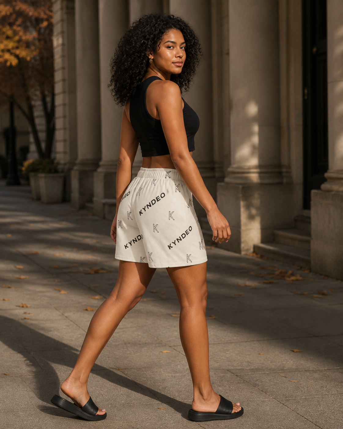 Afro-Latina model wearing KYNDEO Ember Court Short, rear three-quarter view
