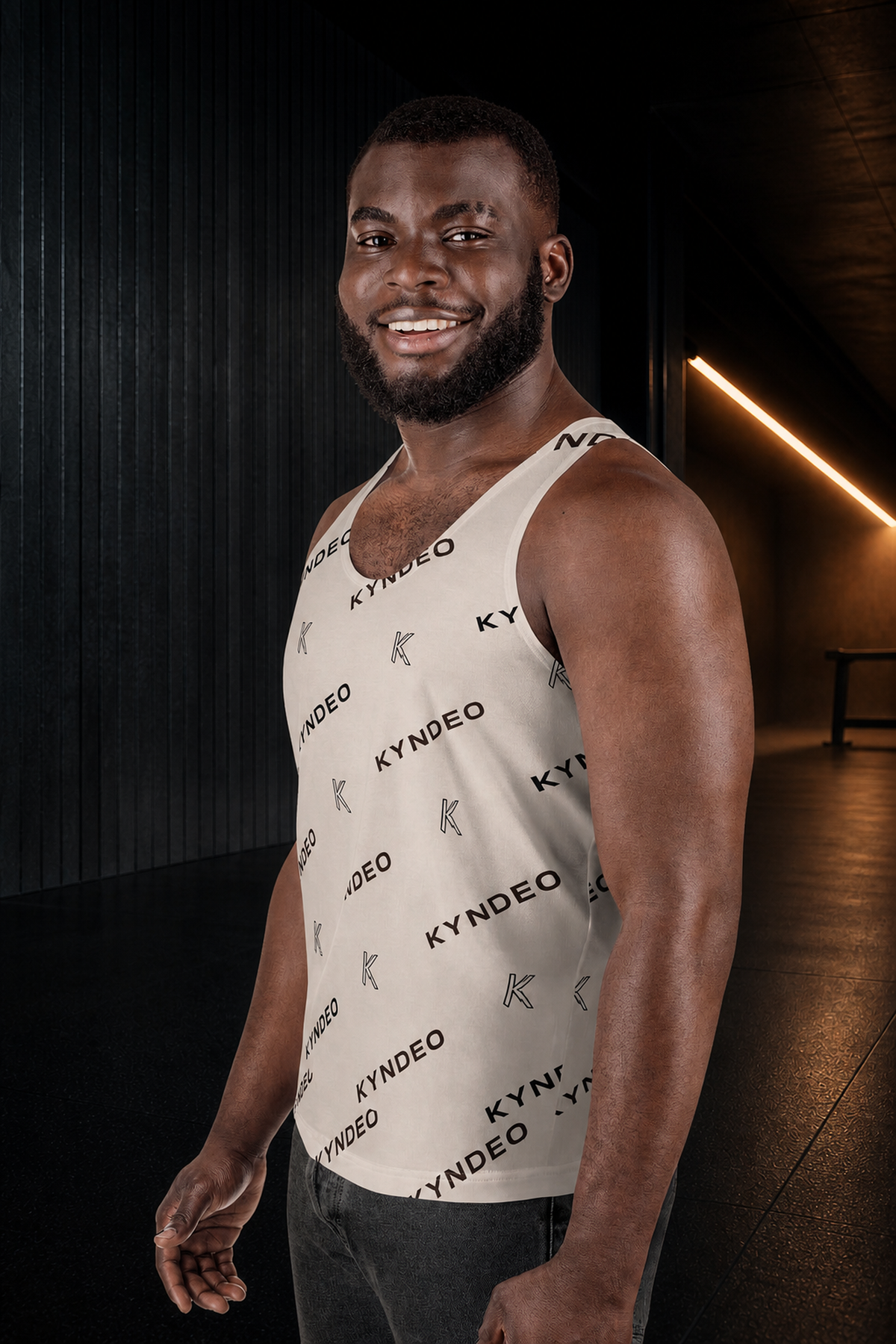 KYNDEO Origin Tank on Black male athlete, front three-quarter view in charcoal performance corridor