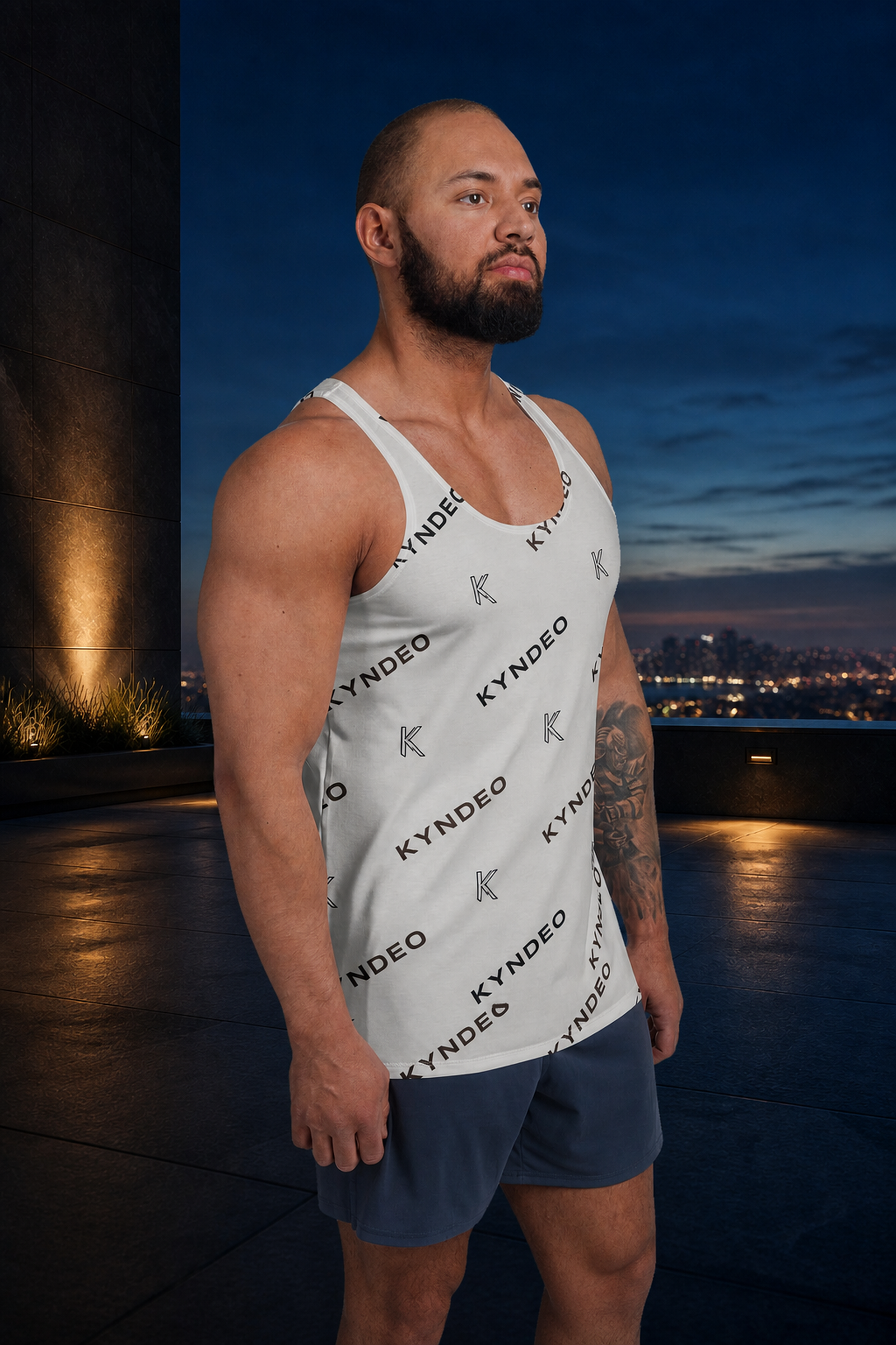 KYNDEO Origin Tank on Afro-Latino male athlete, front three-quarter view at blue-hour rooftop