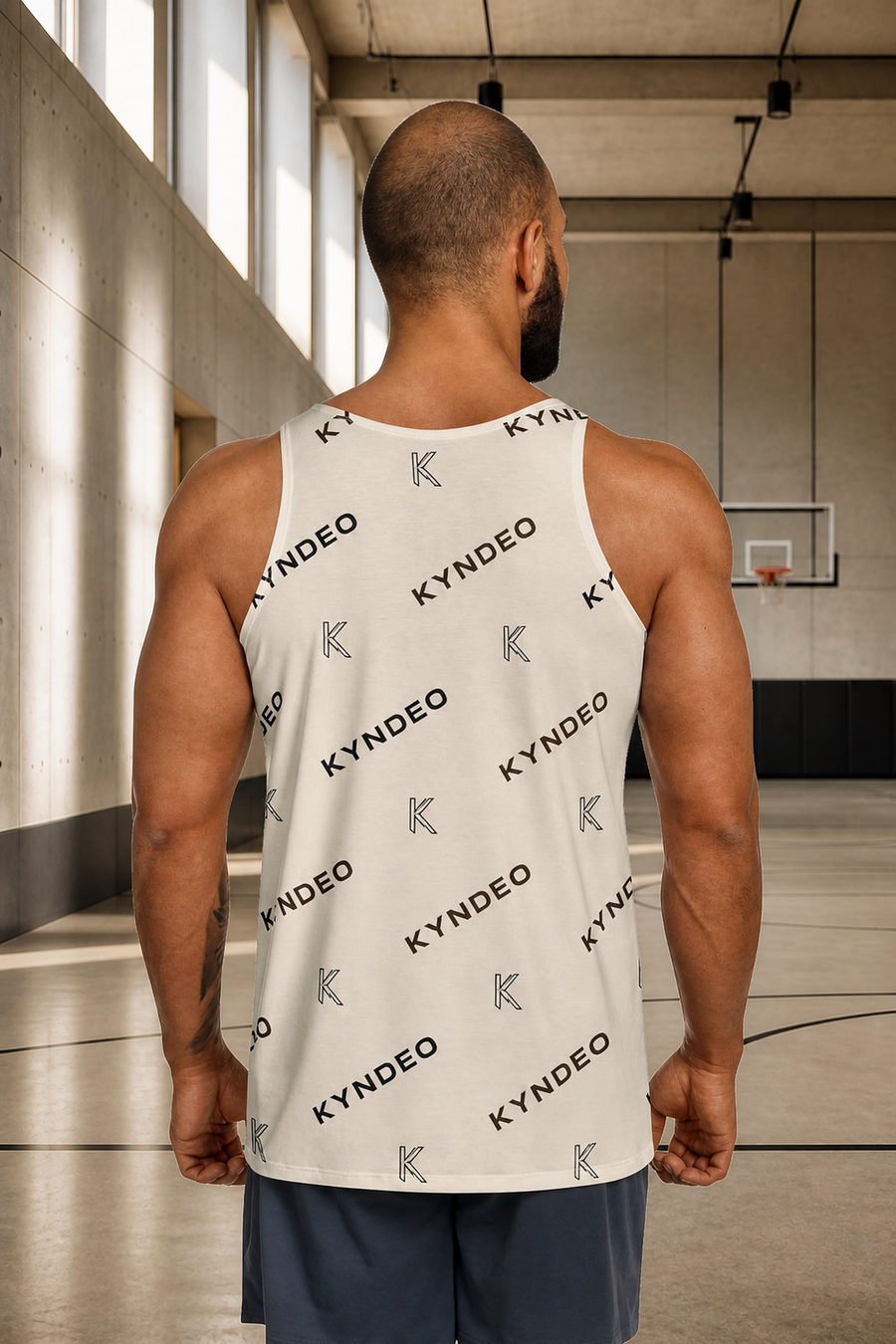 KYNDEO Origin Tank on Afro-Latino male athlete, complete rear view in bright performance hall