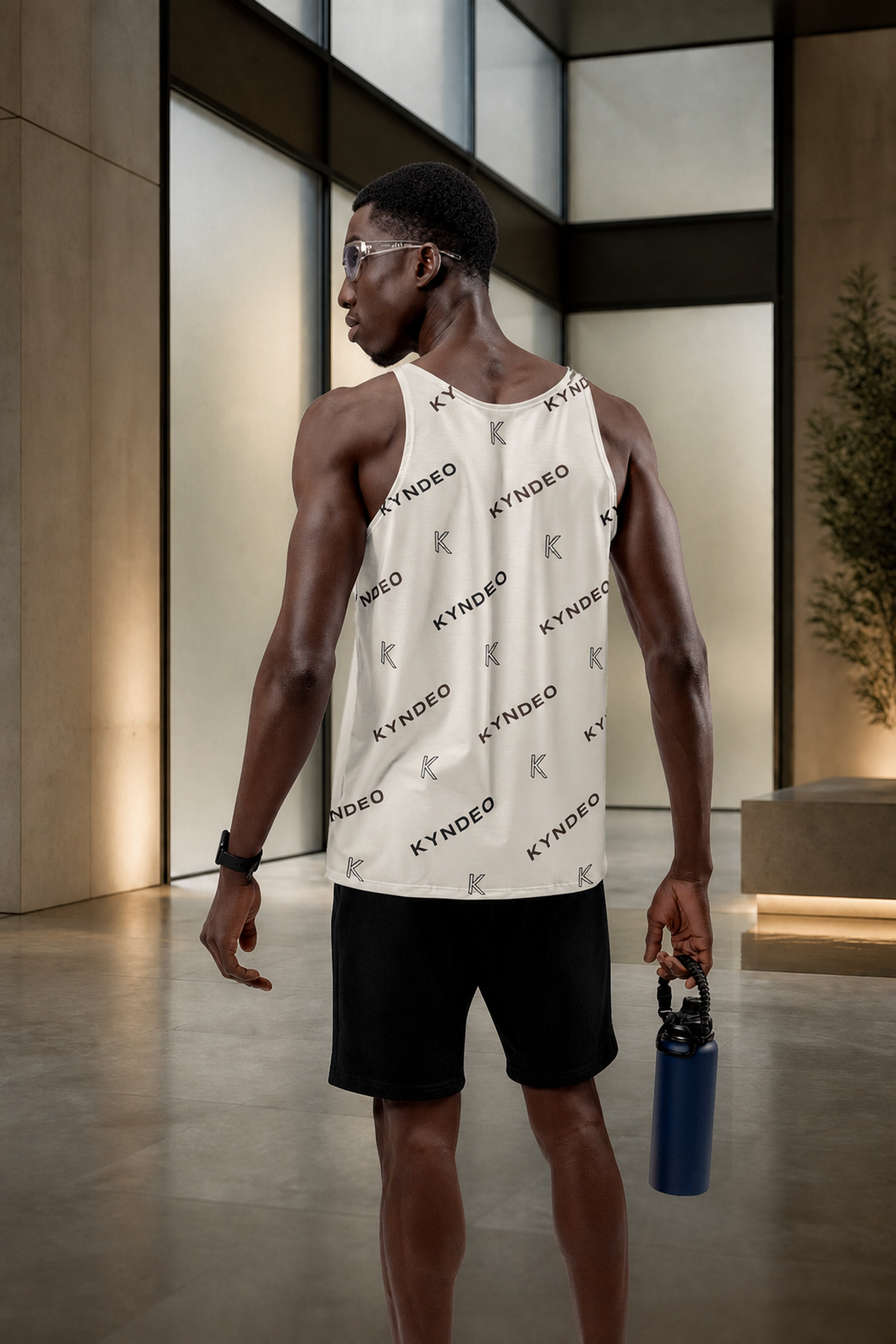KYNDEO Origin Tank on Black male athlete, rear three-quarter view in glass recovery atrium