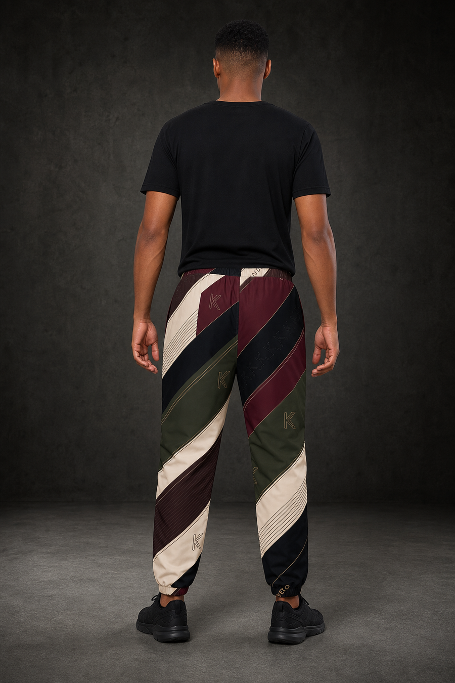 KYNDEO Velocity Track Pant on Afro-Latino male model, complete rear view