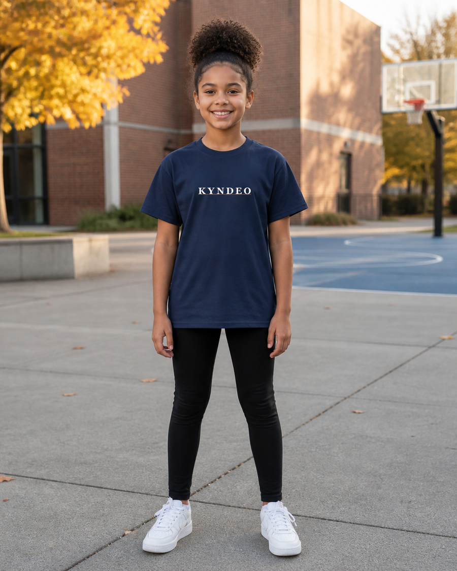 True Navy KYNDEO Youth Core Tee front on an Afro-Latina girl model