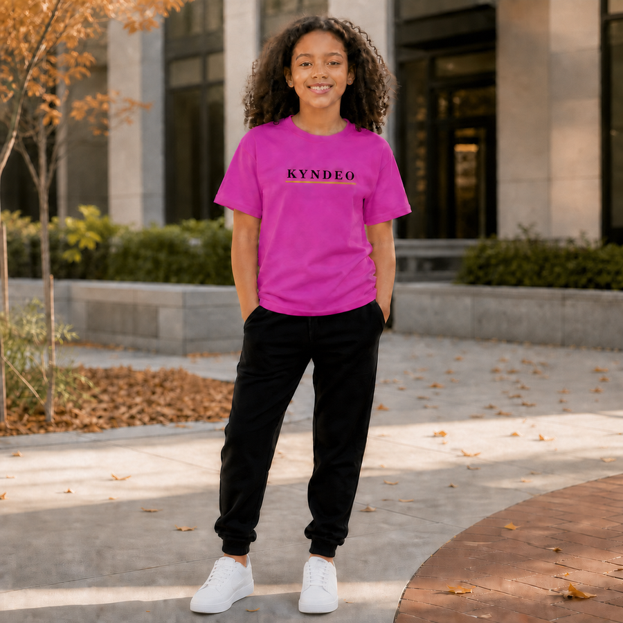 KYNDEO Youth Pop Tee on an Afro-Latina girl model in a modern fall courtyard