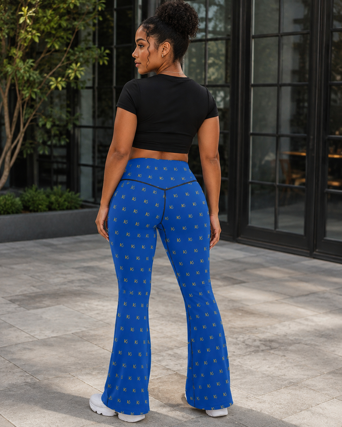 KYNDEO Contour Flare Pant — Royal Monogram — rear three-quarter lifestyle view with black thread