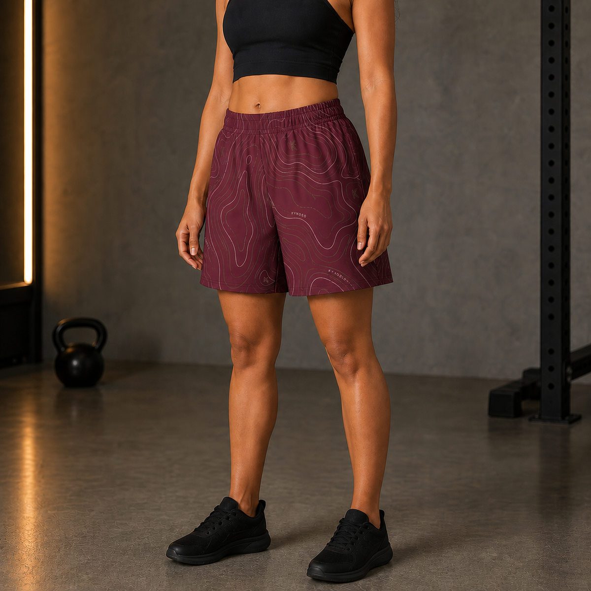 KYNDEO Oxblood Court Short complete front three-quarter view on Afro-Latina athlete