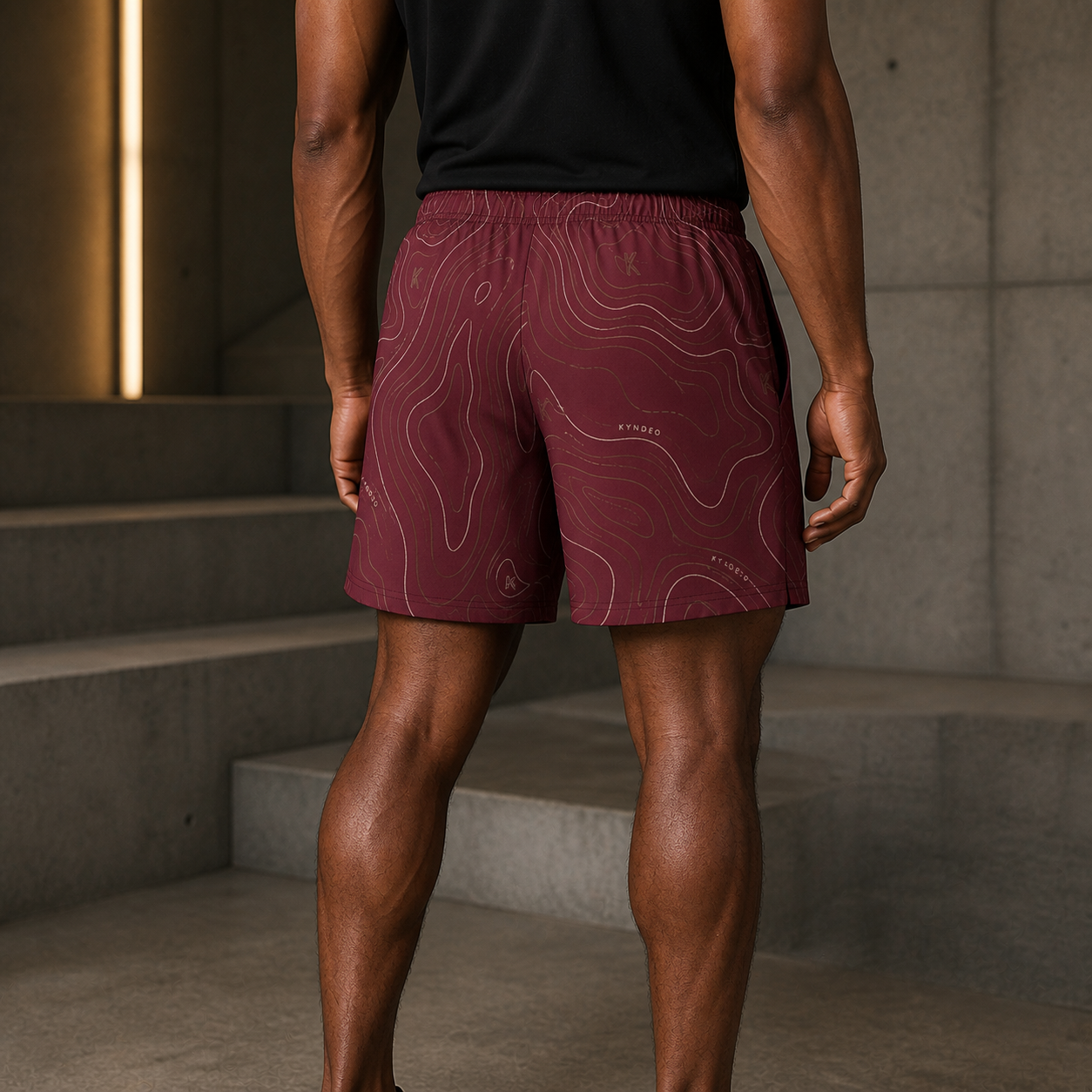 KYNDEO Oxblood Court Short complete rear three-quarter view on Afro-Latino athlete