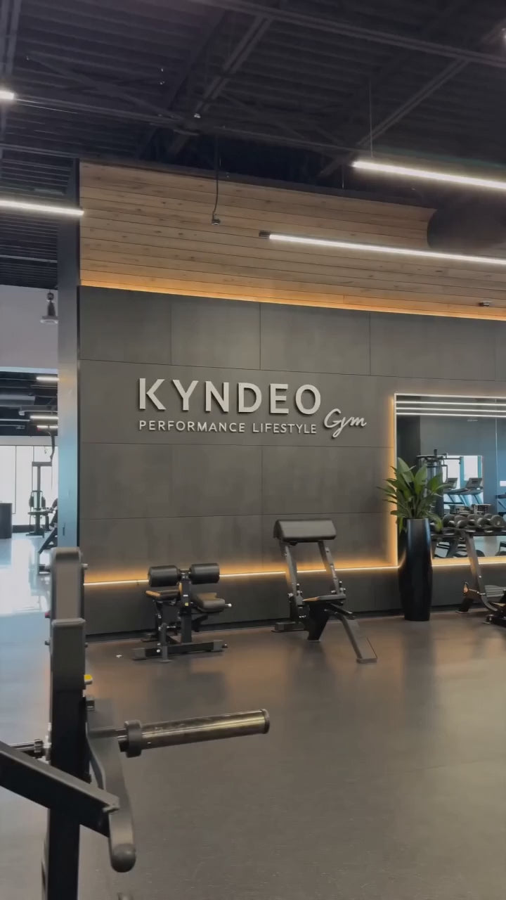 Bryan Frazier trains on chest day wearing a red KYNDEO performance shirt.